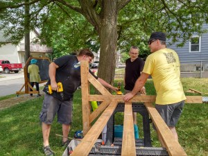 neighbours work together to assemble the chalkboards