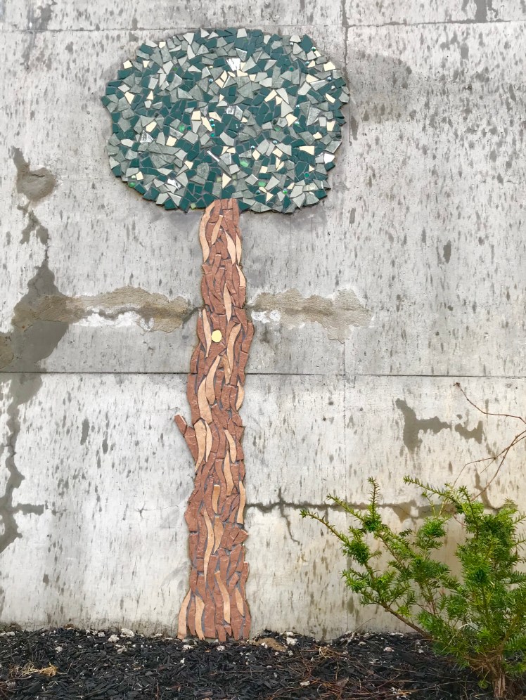 Mosaic tree art on concrete wall